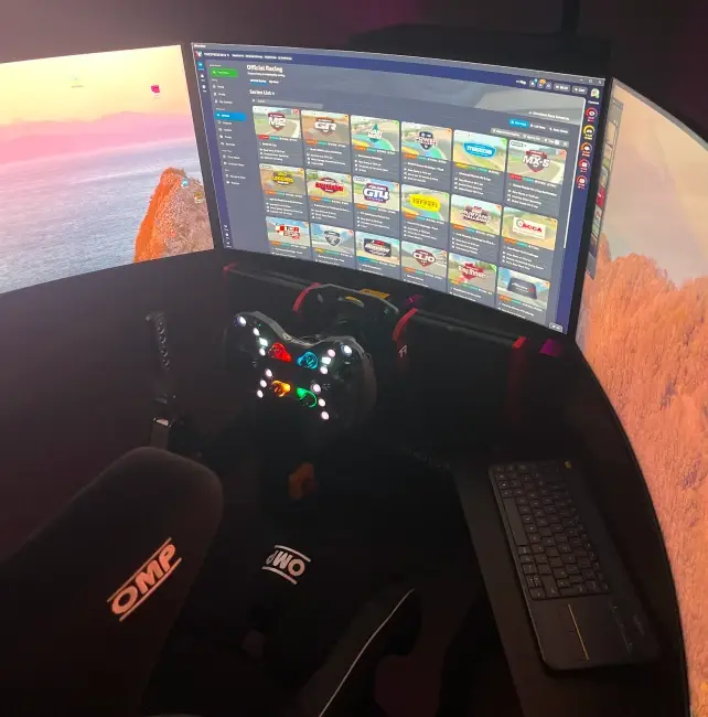 A sim racing rig in a darkened room — bucket seat, direct-drive wheel and a curved monitor showing iRacing's official series list