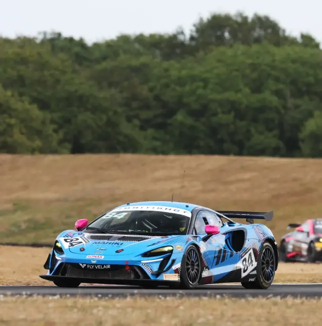 The number 84 Mahiki Racing McLaren Artura GT4 on track in British GT, another GT4 car following behind