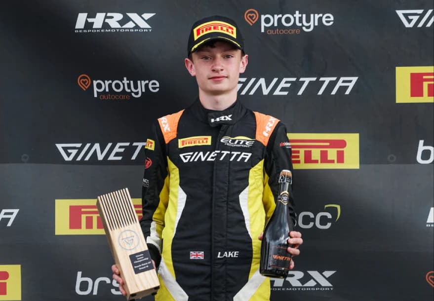 Revie Lake in Mahiki Racing overalls and a number 84 cap on the grid before a British GT race