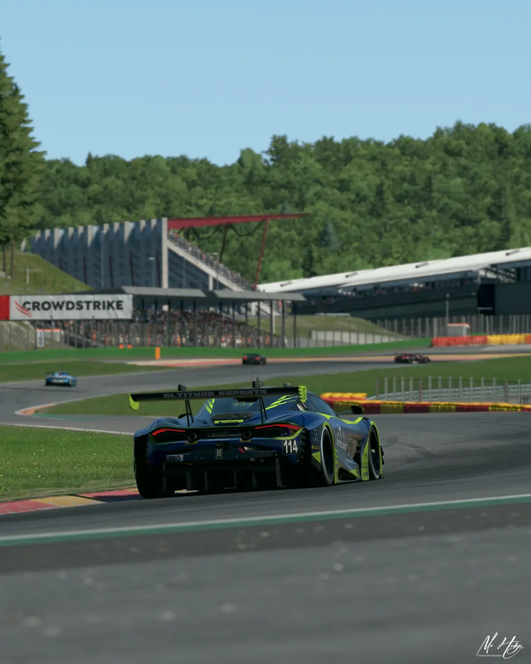 The number 114 Altitude Esports McLaren 720S GT3 heading towards the Spa-Francorchamps grandstands