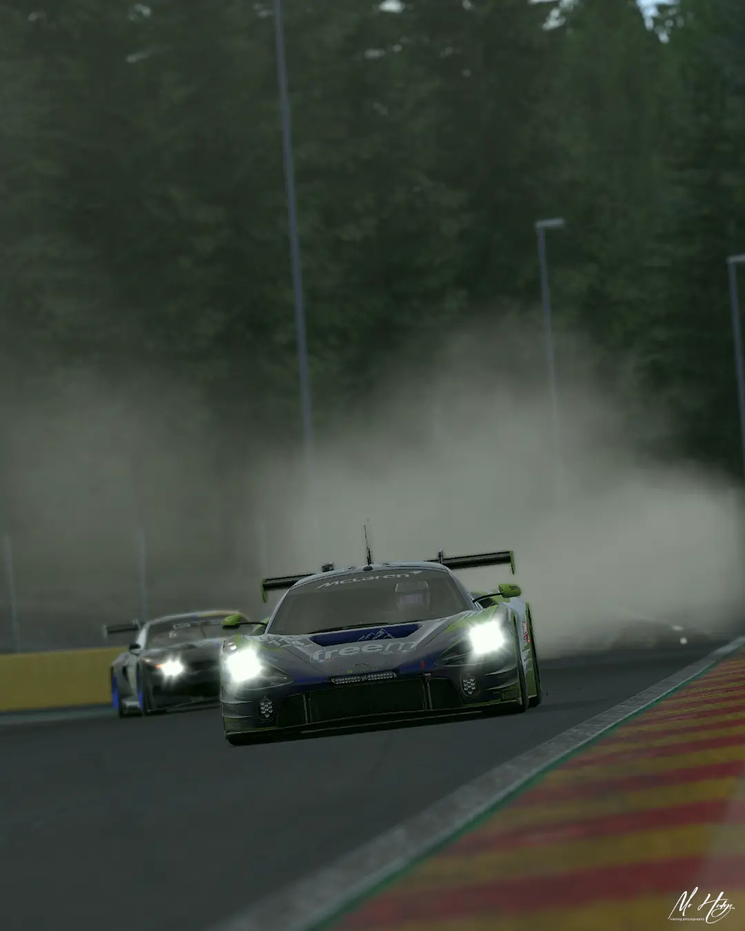 The number 114 Altitude Esports McLaren 720S GT3 on headlights through spray at Spa-Francorchamps
